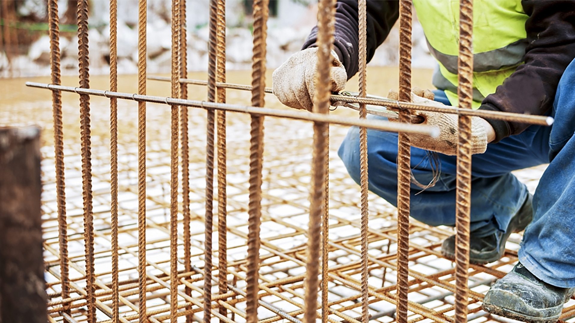 Construction worker installing a foundation for an industrial building.