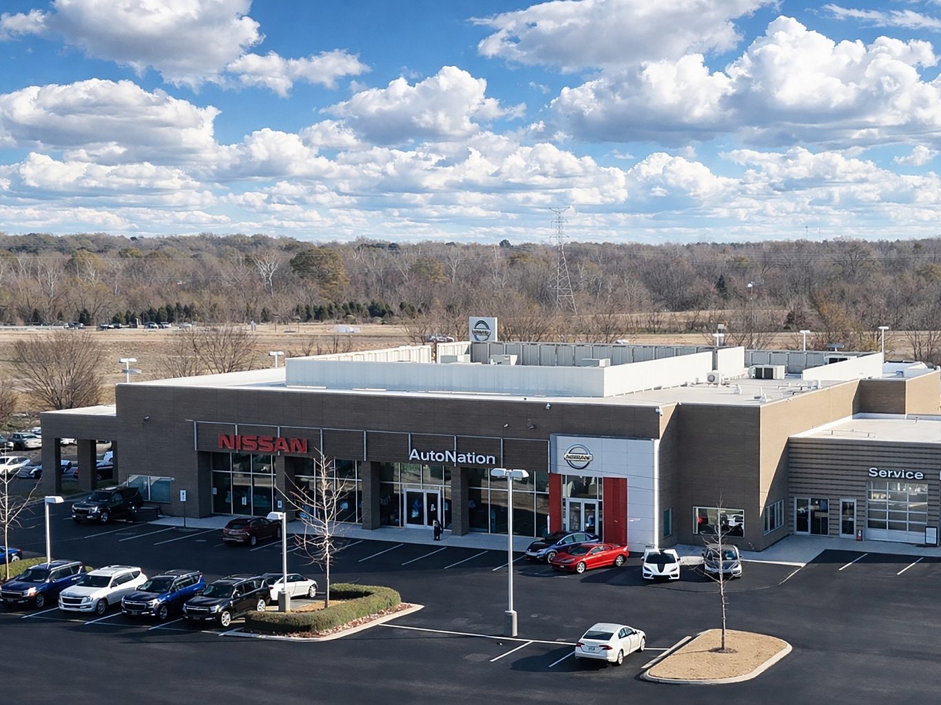 Aerial view of a Nissan car dealership with cars in the parking lot