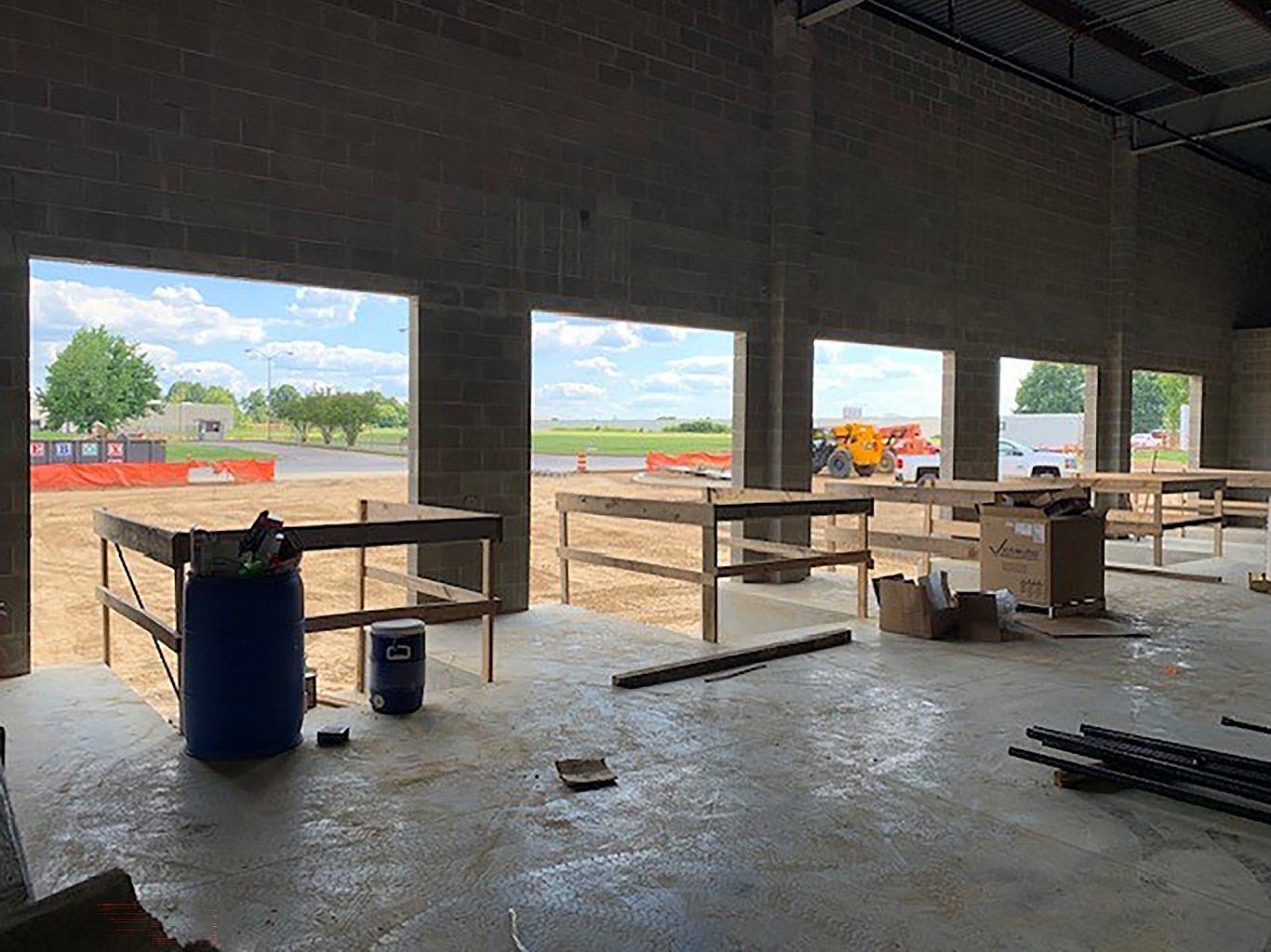 A loading dock in construction looking from the interior out with 5 loading bays.