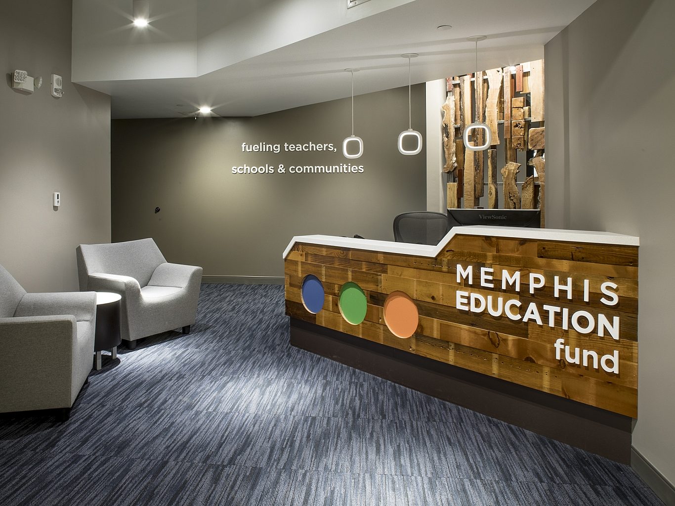 The entrance to the Memphis Education Fund. A receptionist's desk is on the right, and two chairs in the waiting room on the left.