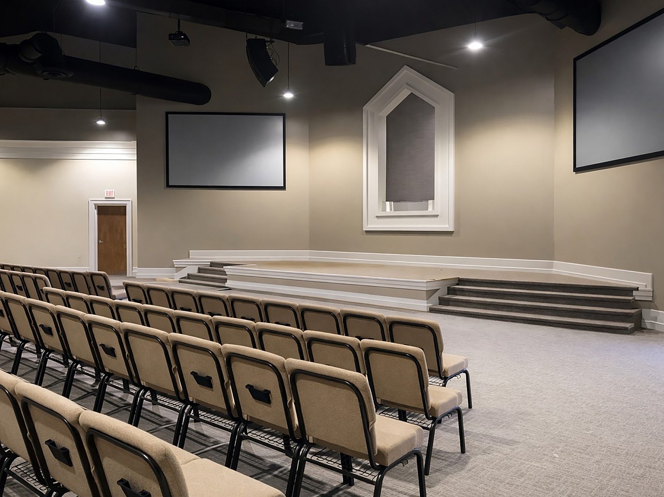 A church sanctuary with rows of chairs facing the stage.