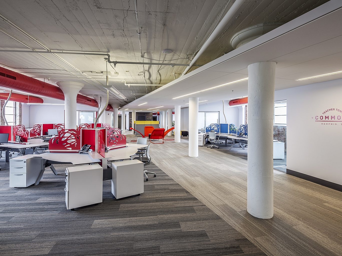 The inside of an office with red and white furniture