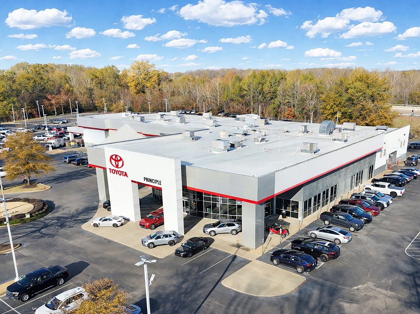 Aerial view of a Toyota car dealership with red accents on the trim