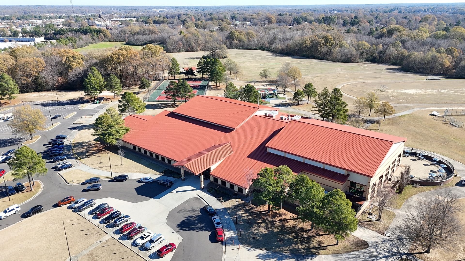 Exterior view of a community center with a red roof