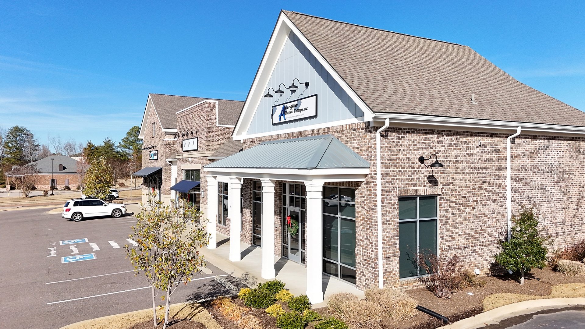 The exterior of a physical therapy clinic with a green awning from the side.