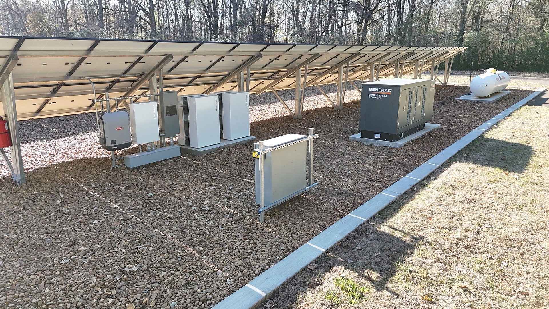 The backside of a solar panel, including generators next to it.