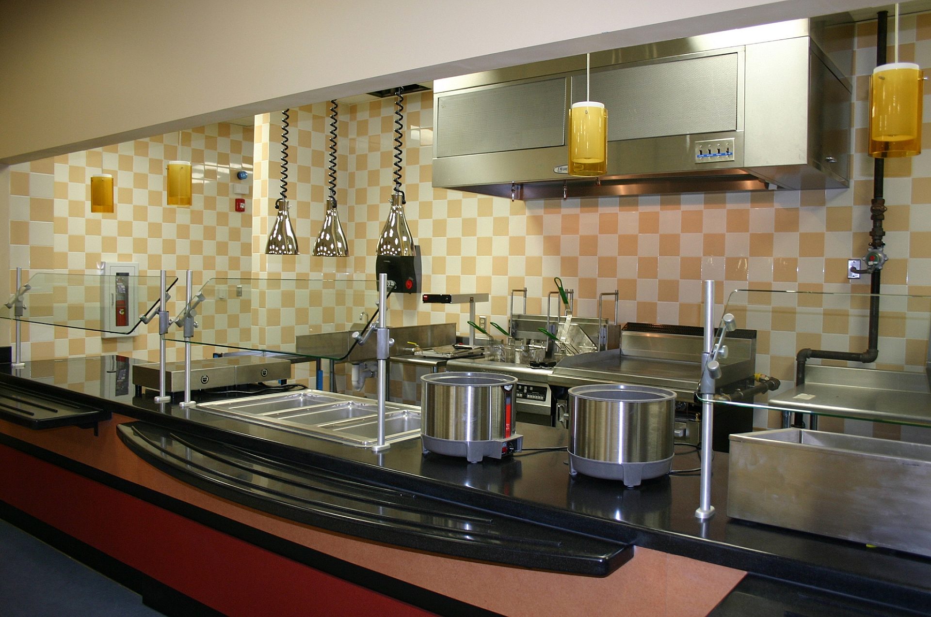 A cafeteria kitchen with yellow and white check tile on the walls