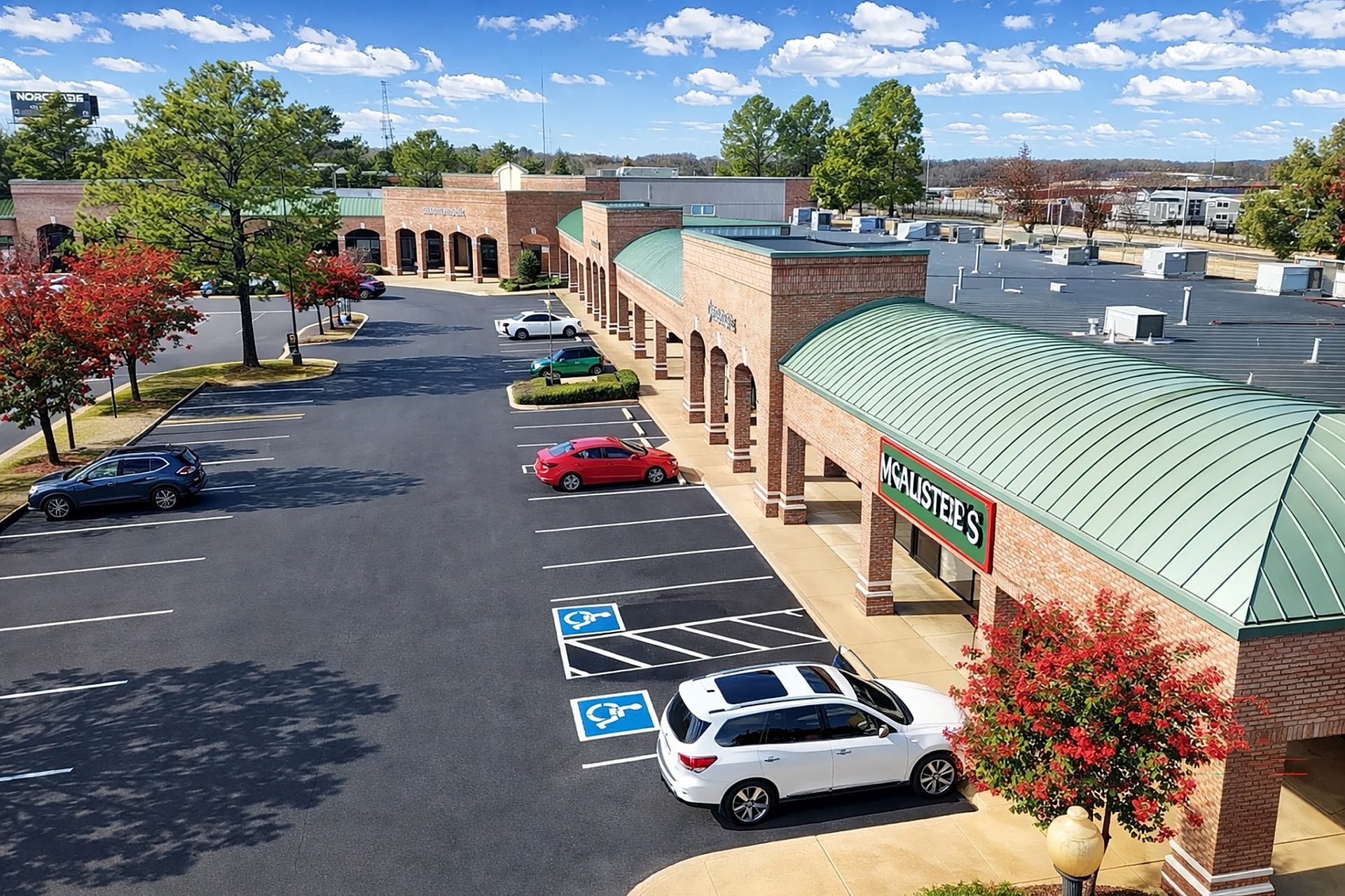 Aerial view of a shopping center and its parking lot.
