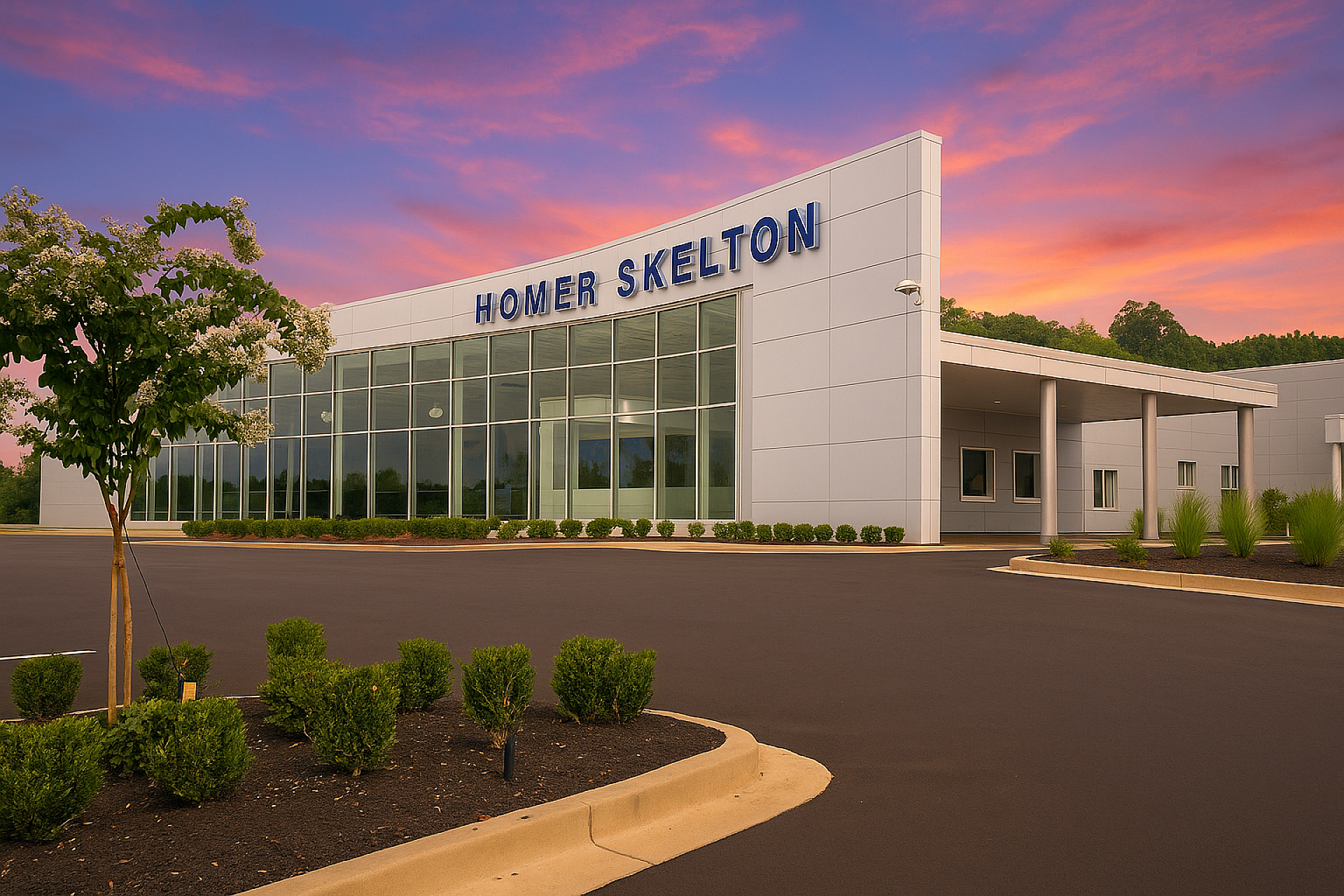 Exterior view of a Ford dealership with Homer Skelton written at the top of the wall. Windows span one side of it.