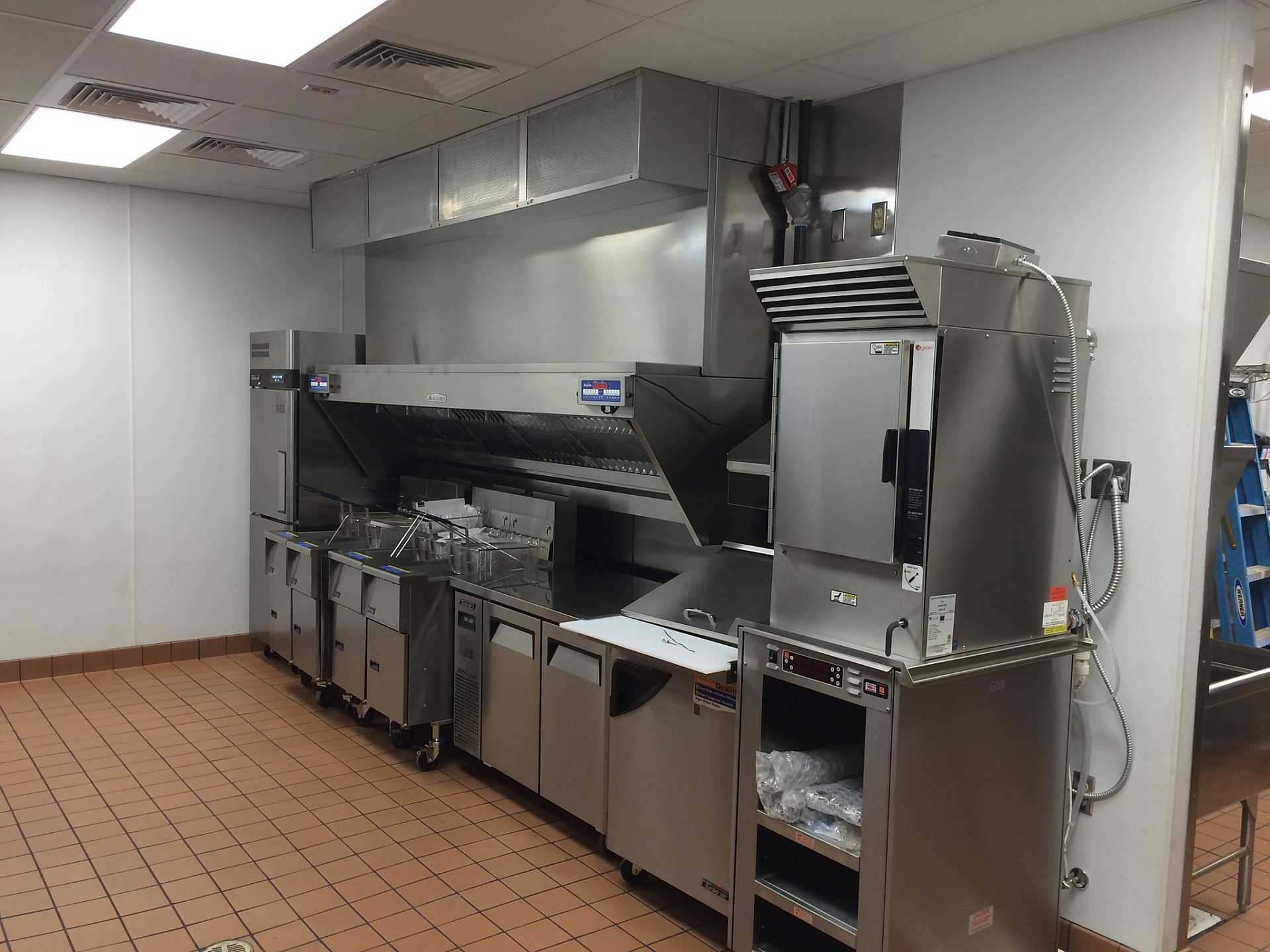 Appliances in the kitchen of a fast food restaurant.
