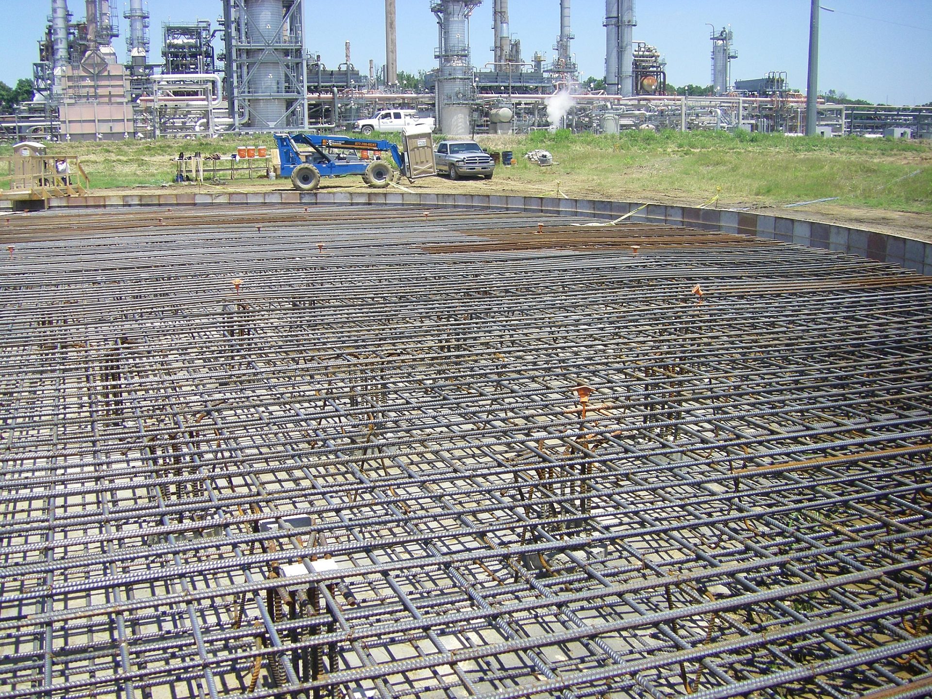 A construction site with the iron framework for the foundation in place