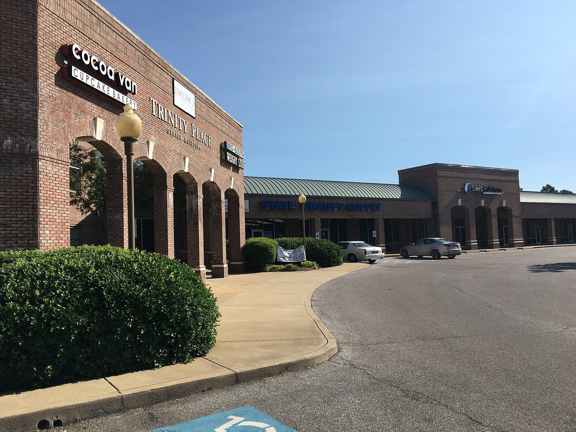 The exterior of a shopping center viewed from the side.