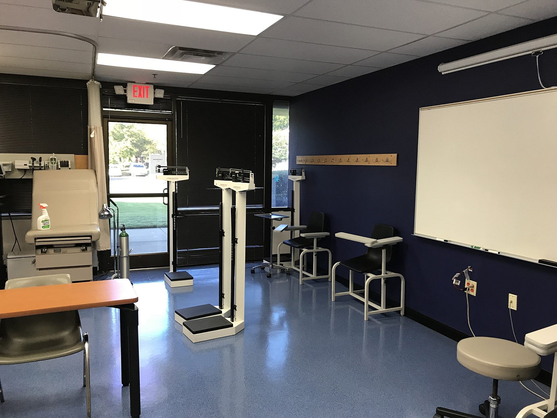 A whiteboard on the wall of a classroom in a dental lab.