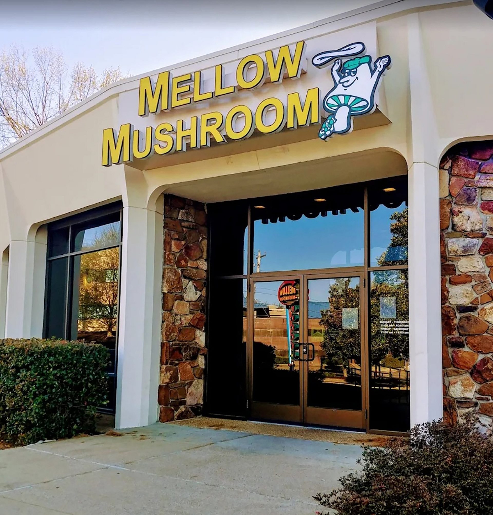 The entrance to a Mellow Mushroom restaurant with their logo above the door