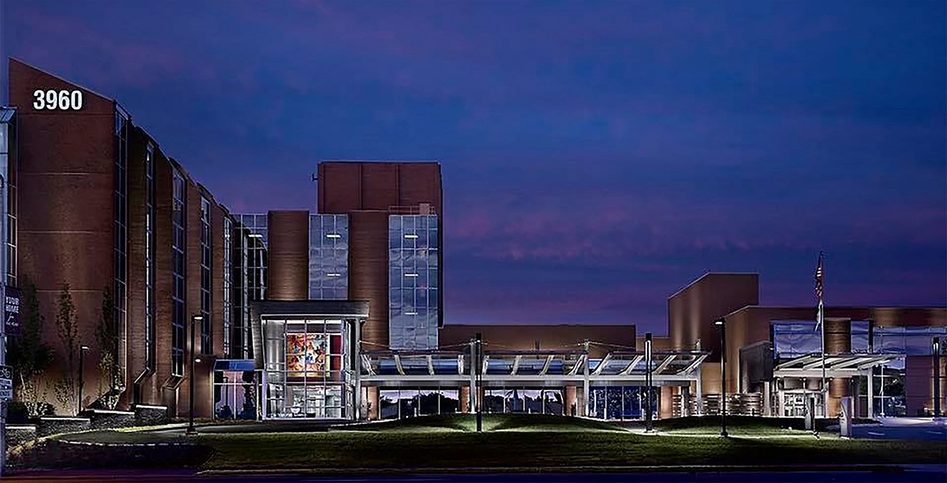 Entrance to a hospital building with a canopy to drive under at night