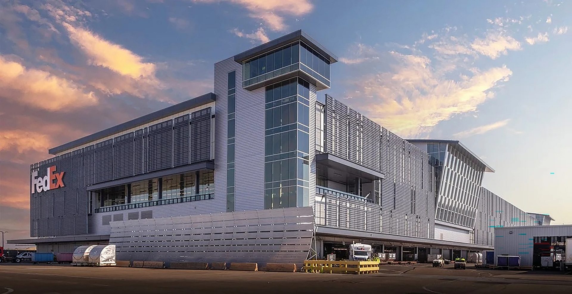 The exterior of Fedex's sorting facility at sunset.