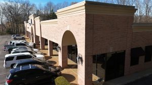 A shopping center with parks parked out front.