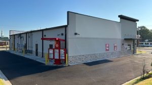 The rear view of a shopping center featuring a drive through.