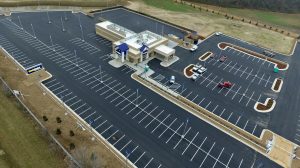 Aerial view of a Carmax dealership with a large parking lot.