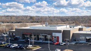Aerial view of a Nissan car dealership with cars in the parking lot