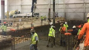 Several construction workers in a building under construction.