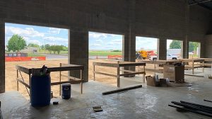 A loading dock in construction looking from the interior out with 5 loading bays.
