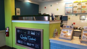 The order counter at a Captain D's with the menu in the background.