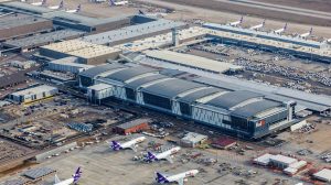 An aerial view of Fedex's sorting facility with several planes parked outside of it.