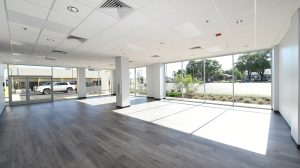 An empty room with floor to ceiling windows on two sides.