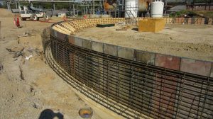 A construction site with an iron framework supporting the foundation