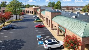 Aerial view of a shopping center and its parking lot.