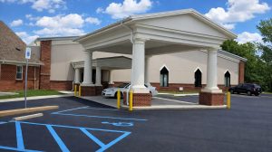 The entrance to a church building featuring a covered area in case of rain.