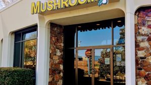 The entrance to a Mellow Mushroom restaurant with their logo above the door