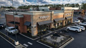 Aerial view of a three bay shopping center in Collierville, TN with a patio and drive through.