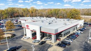Aerial view of a Toyota car dealership with red accents on the trim