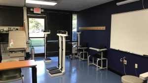 A whiteboard on the wall of a classroom in a dental lab.