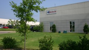 The exterior view of an office complex with a tree in the foreground