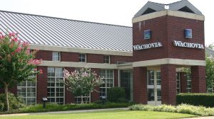 The exterior view of Wachovia Bank with a lawn and trees in front.
